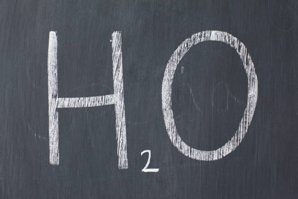 istock Chemical symbol for water written on a blackboard 826163152