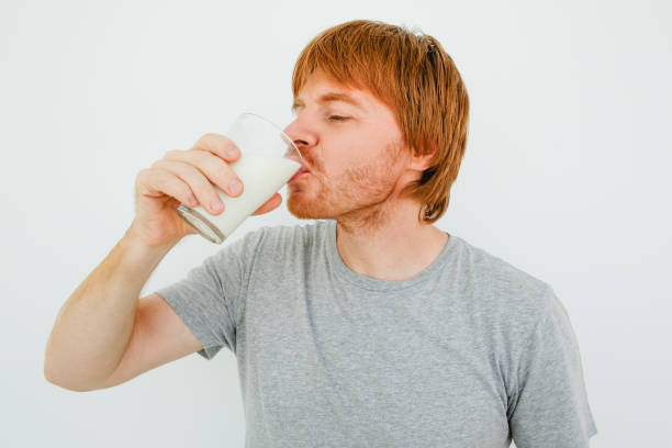 istock Handsome Red-haired Man Drinking Milk From Glass 826163910