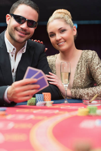 istock Couple sitting at the poker table smiling 826166502