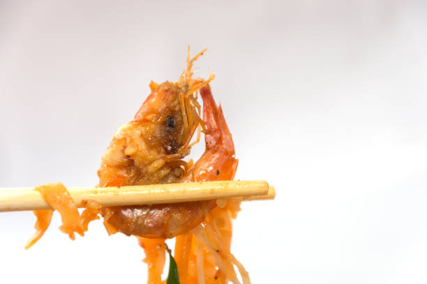 seafood pad thai on plate with chopsticks