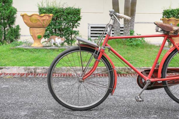 istock bicycle red  classic vintage in former on road background with copy space for add text 826174692