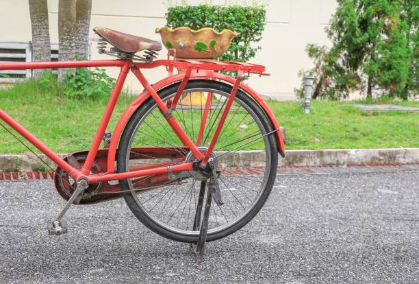 istock bicycle red  classic vintage in former on road background with copy space for add text 826174724