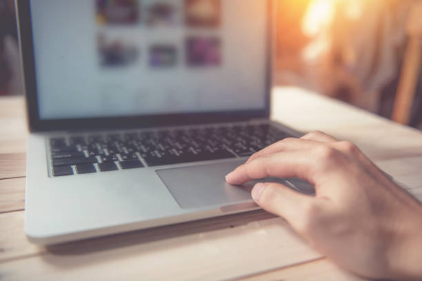 istock Man hand using touchpad on laptop at home 826175066