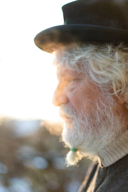 istock Side view of Senior with old hat on his head and beard brush 826175318
