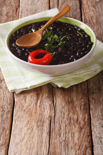 istock stewed black beans with spices and herbs in a bowl close-up. vertical 826179678