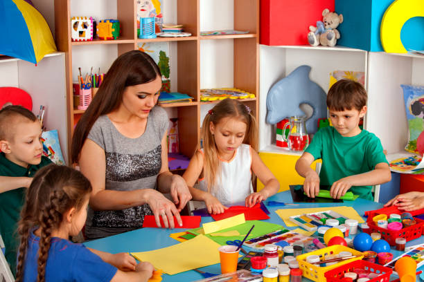 istock School children with scissors in kids hands cutting paper . 826179812