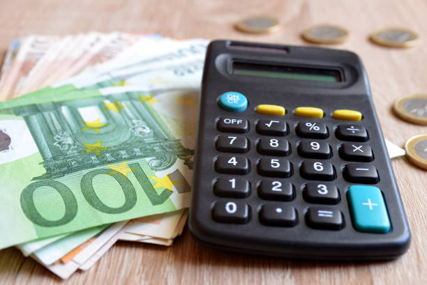 istock Euro coins and banknote with calculator. 826183188