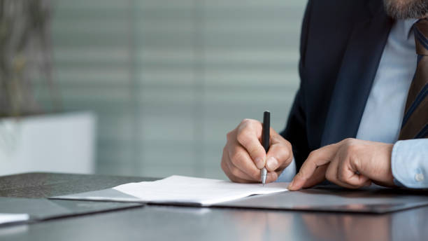 istock Hands of businessman signing contract 826183496