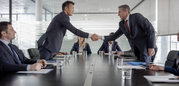 istock Businessmen shaking hands after signing contract 826183606