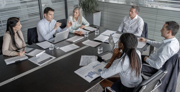 istock Coworkers discussing details of project with their project manager 826183690