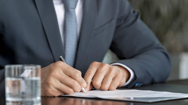 istock Hands of businessman signing contract 826183808