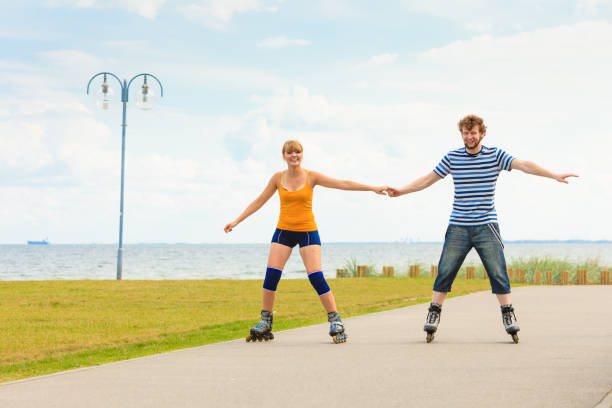 istock Young couple on roller skates riding outdoors 826190964