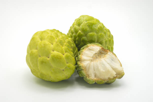 istock Two custard apples and one half custard apple, isolated on background. 826194596