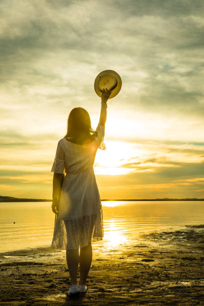 istock woman against sunset by lake 826195004