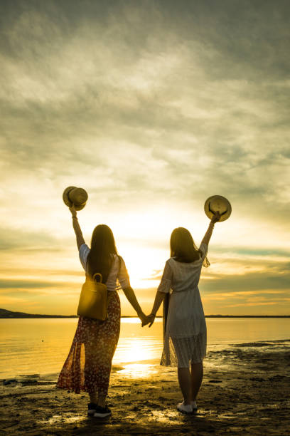 istock Two women standing by at sunset 826195150