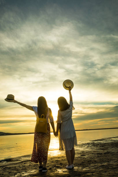 istock Two women standing by at sunset 826195210