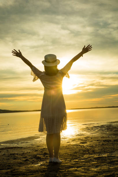 istock woman against sunset by lake 826195338