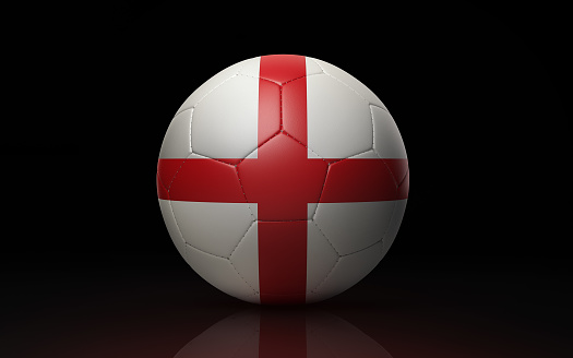 Photorealistic 3d render of a soccer ball textured with English flag on black background. Soccer ball is lit by the upper left corner of the composition and casting shadows and reflections on black ground. Horizontal composition with copy space. Clipping path is included.