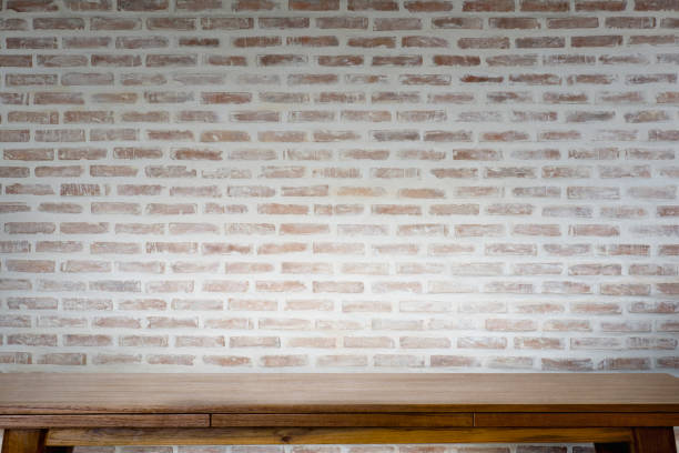istock Mock up wooden table with white brick wall. 826203774