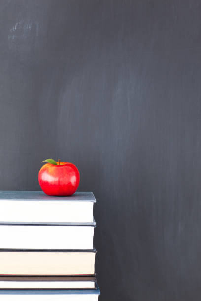 istock A red apple on a stack of books and a clean blackboard 826206854