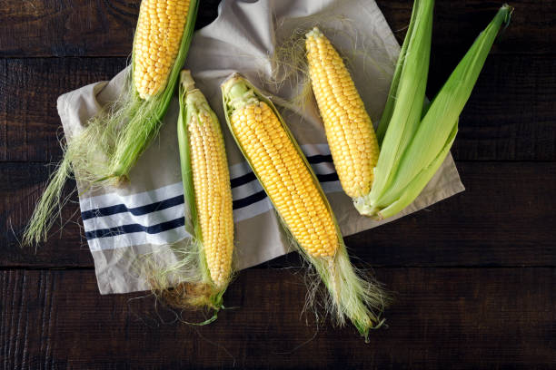 istock Top view fresh corn on cobs on wooden table 826211972