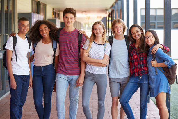 istock Teenage classmates standing in high school hallway 826212676