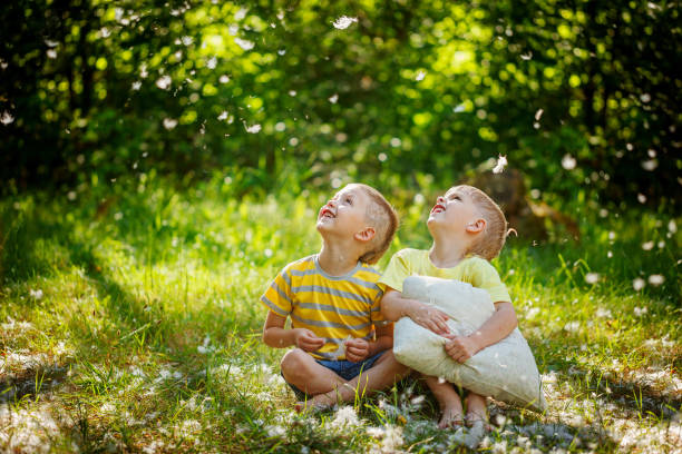 istock Kids having fun with  pillows outdoors. Two children relax in a 826213204