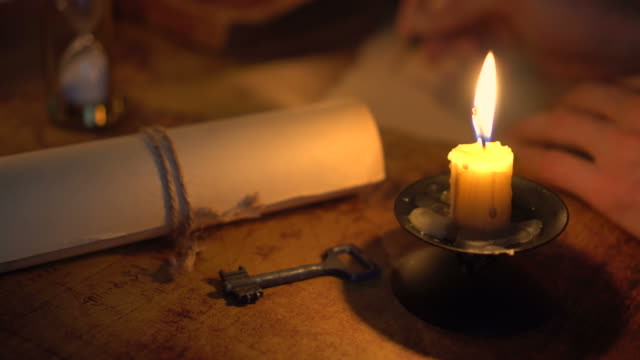 writing letter in candlelight