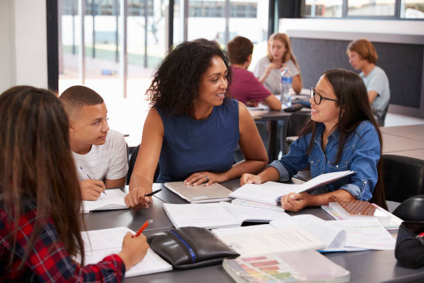 istock Teacher studying school books in class with high school kids 826217146