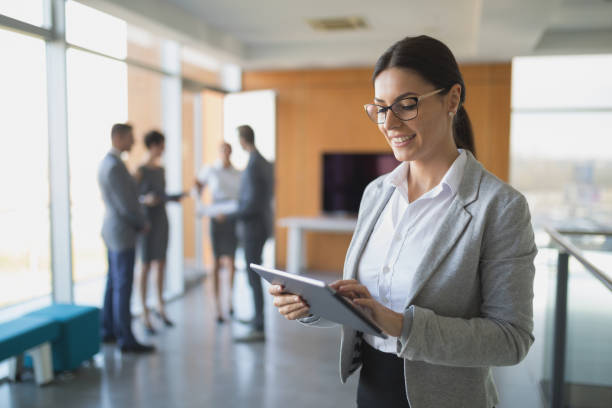 istock Young smiling businesswoman using digital tablet 826232598