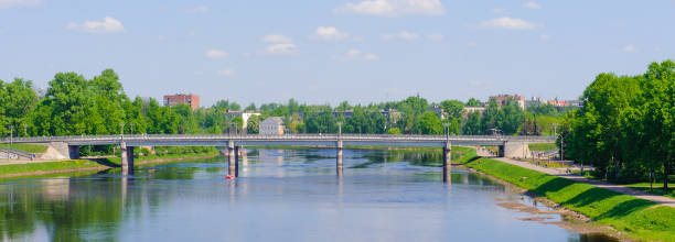 istock Bridge over the river under the blue sky and trees on the coasts 826236950