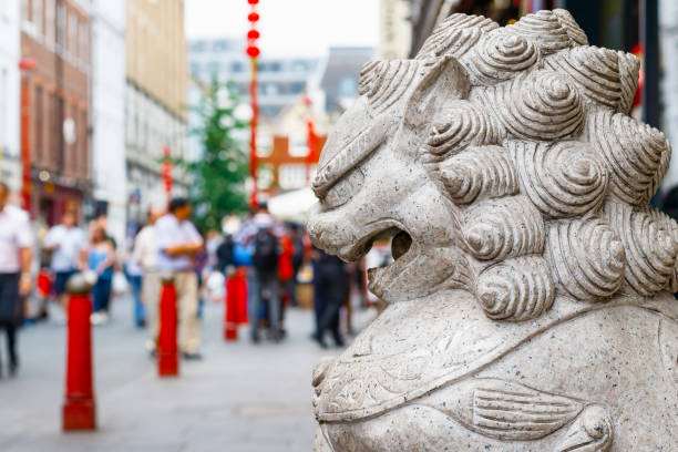 A guardian lion statue in crowded London Chinatown