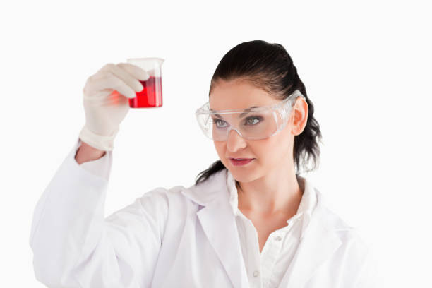 istock Darkhaired woman looking at a red beaker 826254714