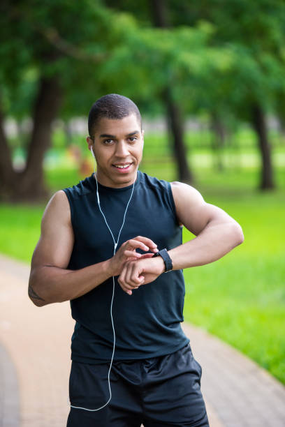 istock african american sportsman using smartwatch 826255076