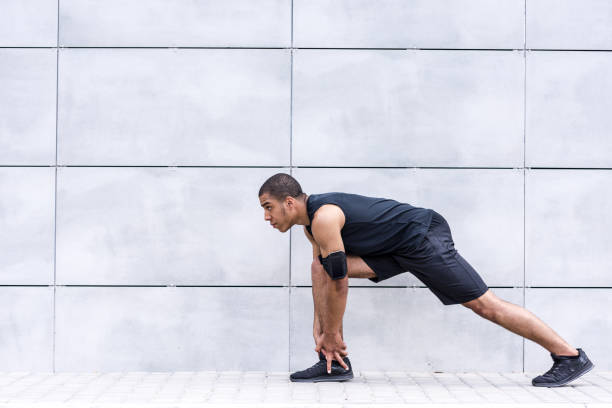 istock african american runner stretching on street 826255886