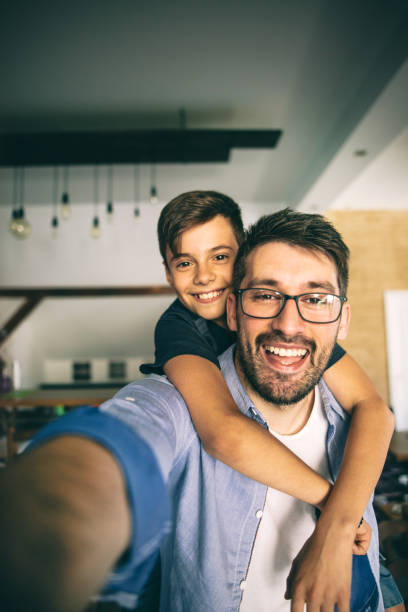 Father taking a selfie with his son