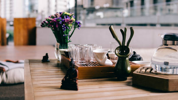 istock Tea ceremony on a shepherd with Buddha figures close-up. Conducting a traditional tea ceremony with Chinese tea 826272524