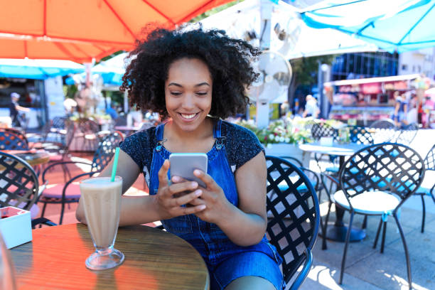 istock Smiling woman relaxing and using smart phone 826273126