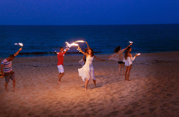 istock Friends celebrating with sparklers on beach 826273128