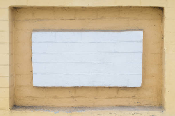 istock Niche in the brick wall painted in white and yellow 826275486