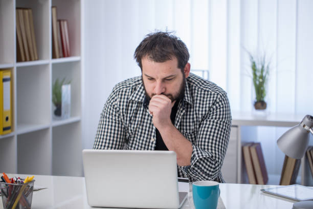 istock Handsome businessman working on laptop in office 826276064