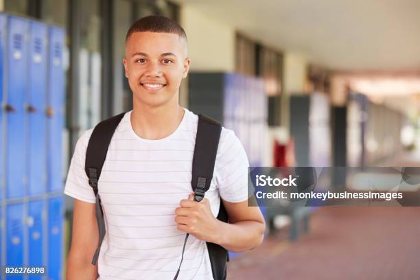 Happy Mixed Race Teenage Boy Smiling In High School Corridor Stock Photo - Download Image Now