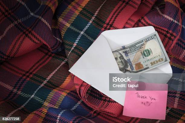 Money In A White Envelope Put On A Blanket Along With A Thank You Message Stock Photo - Download Image Now