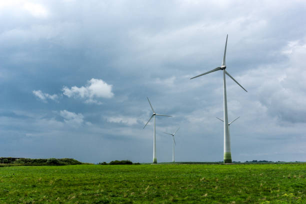 istock Wind Turbines and green fields on a cloudy day. Near storm 826279434