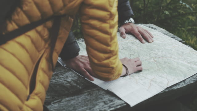 Young couple planning their trip with map. Close up