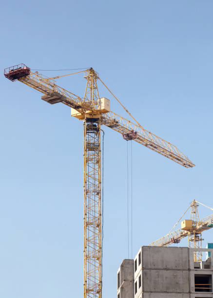 istock Crane and building construction site against blue sky 826288184