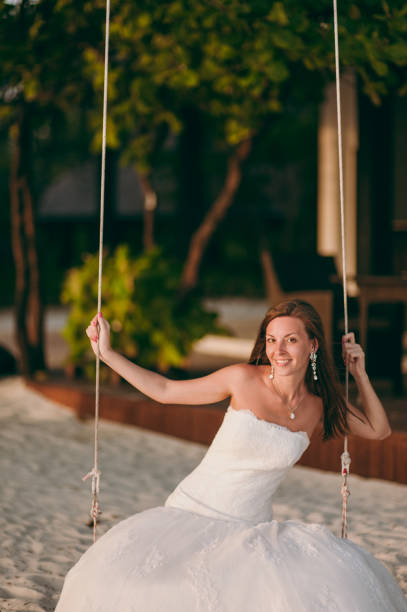 istock Beautiful bride on a swing on the island 826288238