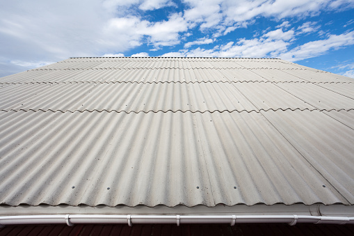 Asbestos slate roof against blue sky