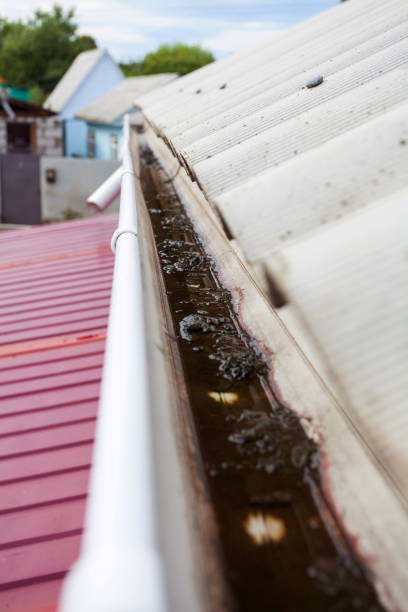 istock Dirty rain gutter on asbestos slate roof need to cleaning 826288834