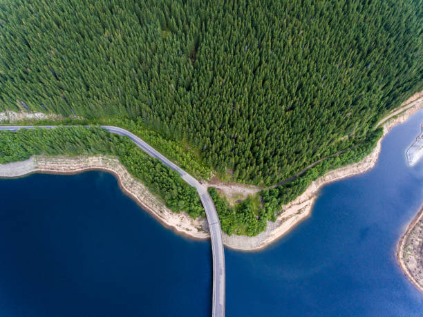 istock Road bridge over lake and mountain forest aerial view 826289164